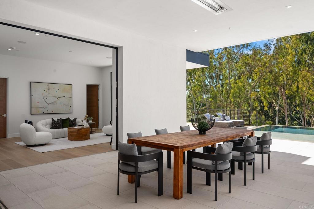 5471-73 La Crescenta Road Rancho Santa Fe, CA 92067 - Photo 17 of 23 a view of a dining room with furniture and chandelier