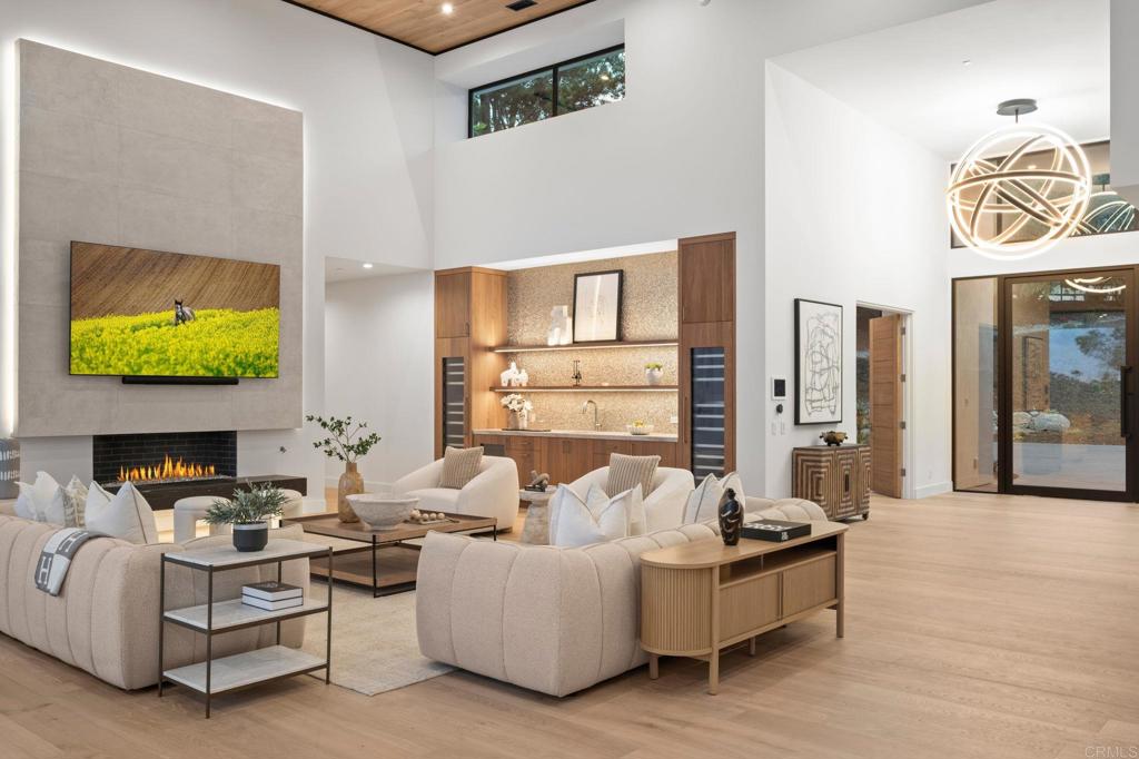 5471-73 La Crescenta Road Rancho Santa Fe, CA 92067 - Photo 19 of 23 a living room with fireplace furniture and a floor to ceiling window