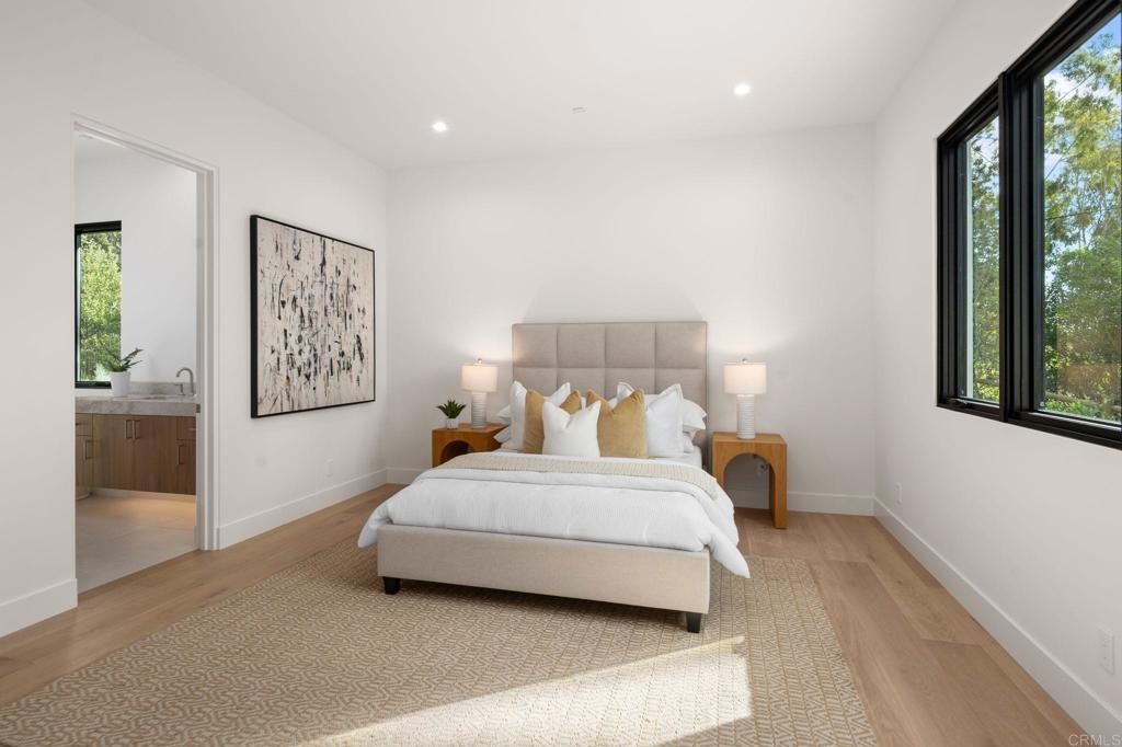 5471-73 La Crescenta Road Rancho Santa Fe, CA 92067 - Photo 22 of 23 a bedroom with a bed and large windows