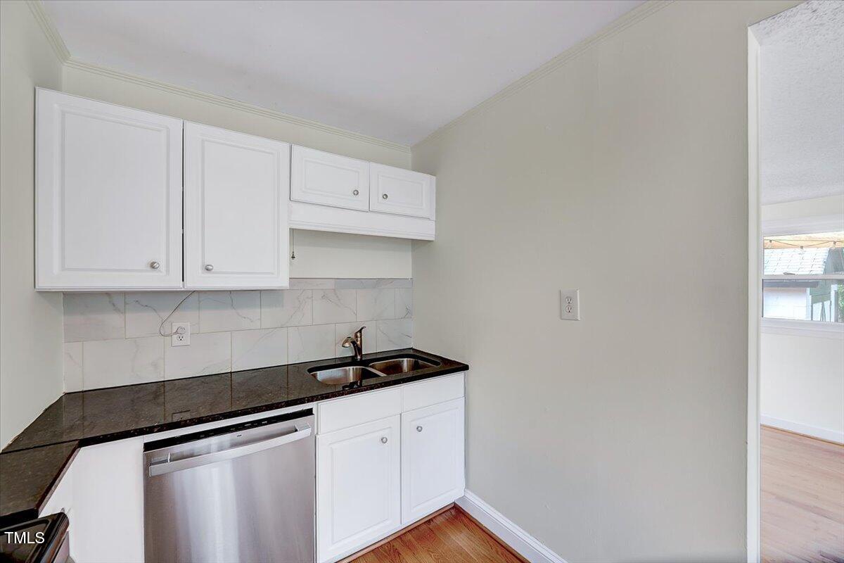 829 Colleton Road Raleigh, NC 27610 - Photo 12 of 27 a kitchen with white cabinets and sink