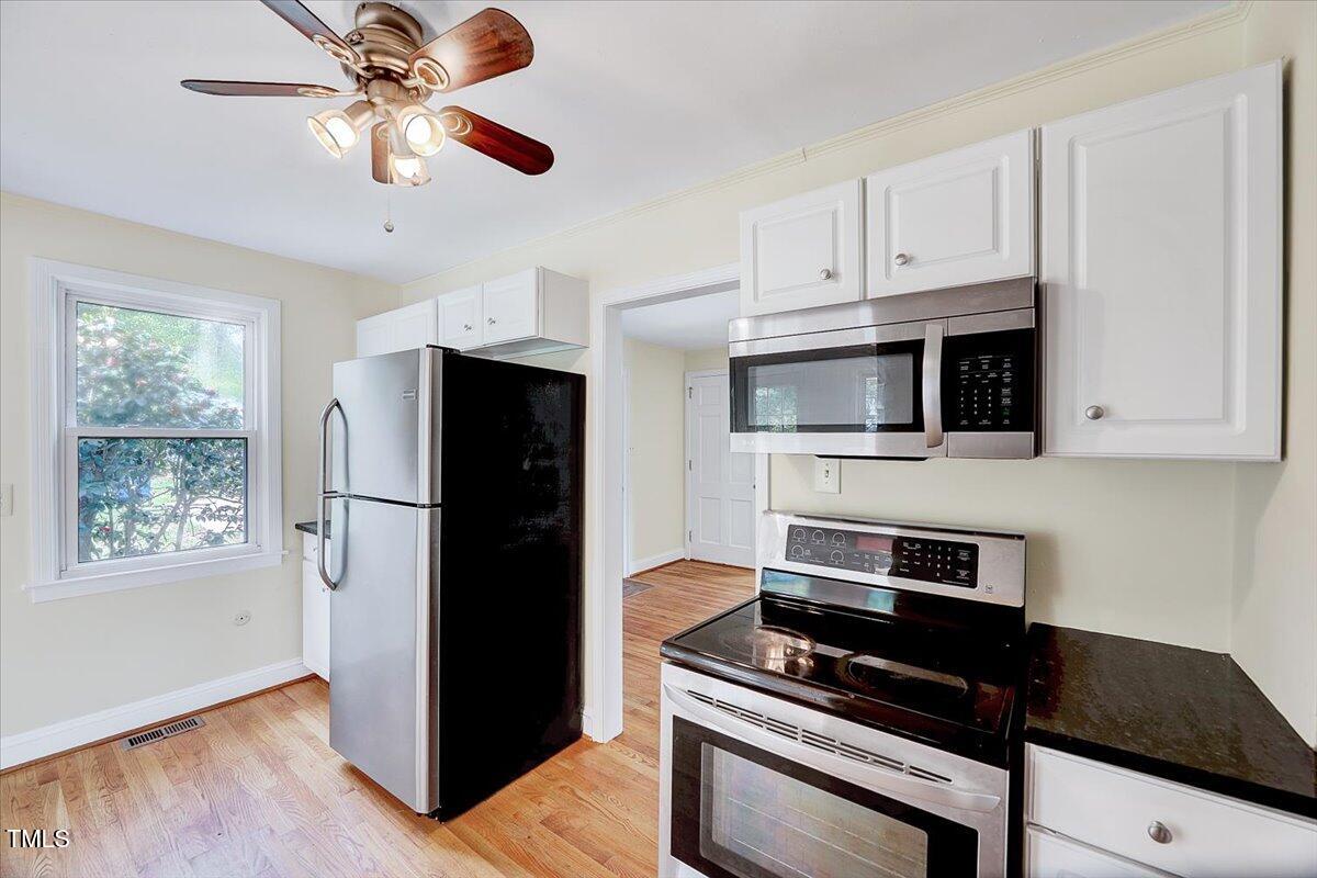 829 Colleton Road Raleigh, NC 27610 - Photo 14 of 27 a kitchen with stainless steel appliances a refrigerator a stove and a microwave