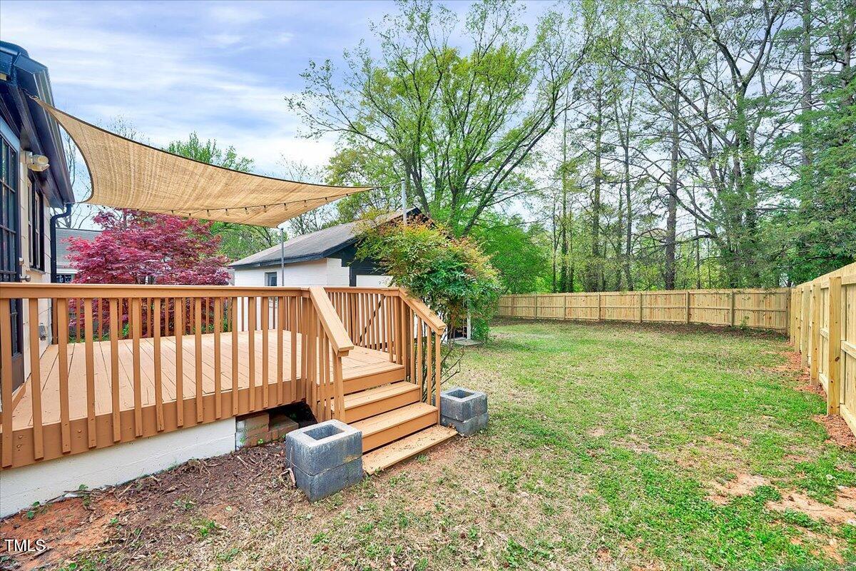 829 Colleton Road Raleigh, NC 27610 - Photo 20 of 27 a view of a backyard with wooden fence