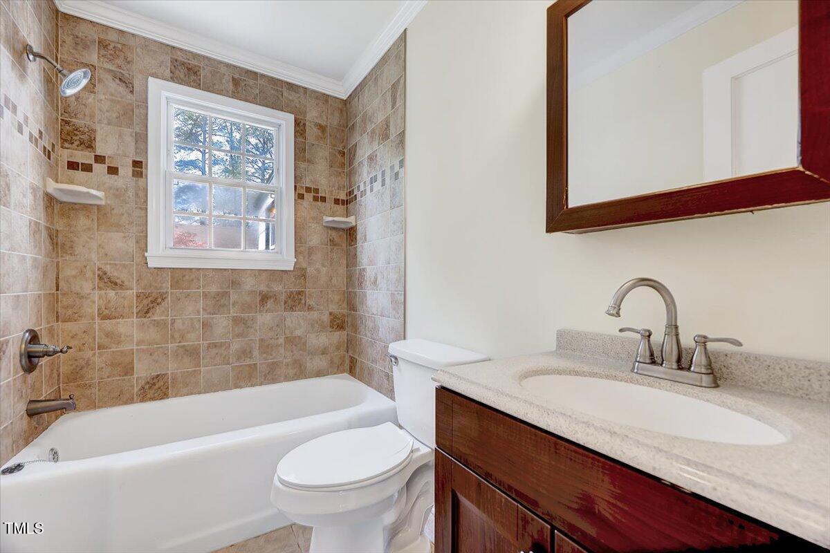 829 Colleton Road Raleigh, NC 27610 - Photo 8 of 27 a bathroom with a sink a toilet and a bathtub