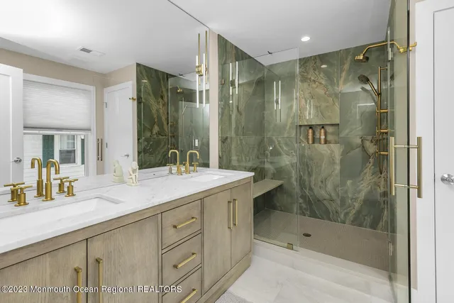 a bathroom with a shower sink and mirror