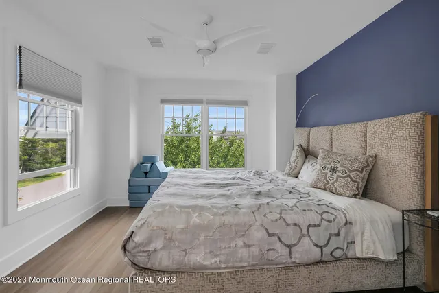 a large bed sitting in a bedroom next to a window