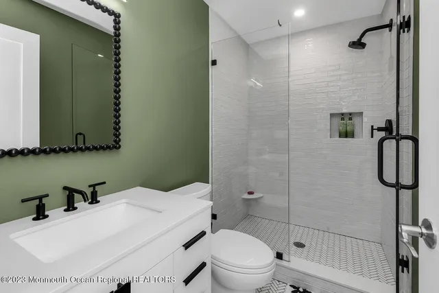 a bathroom with a sink toilet and shower