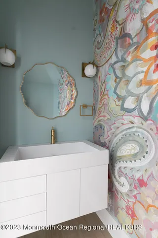 a bathroom with a sink mirror vanity and toilet
