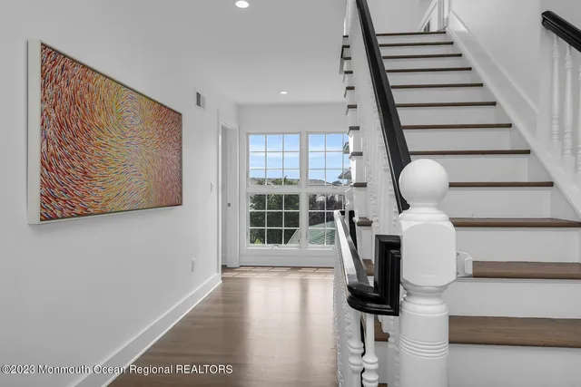 a view of entryway with wooden floor and stairs