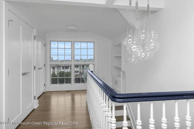 a view of wooden floor and windows in a room