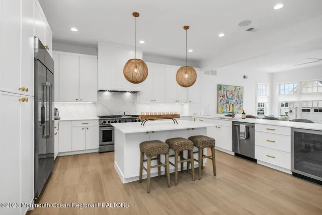 a kitchen with a stove cabinets a dining table and chairs