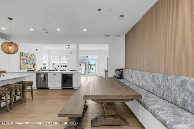 a living room with stainless steel appliances kitchen island furniture and a view of kitchen