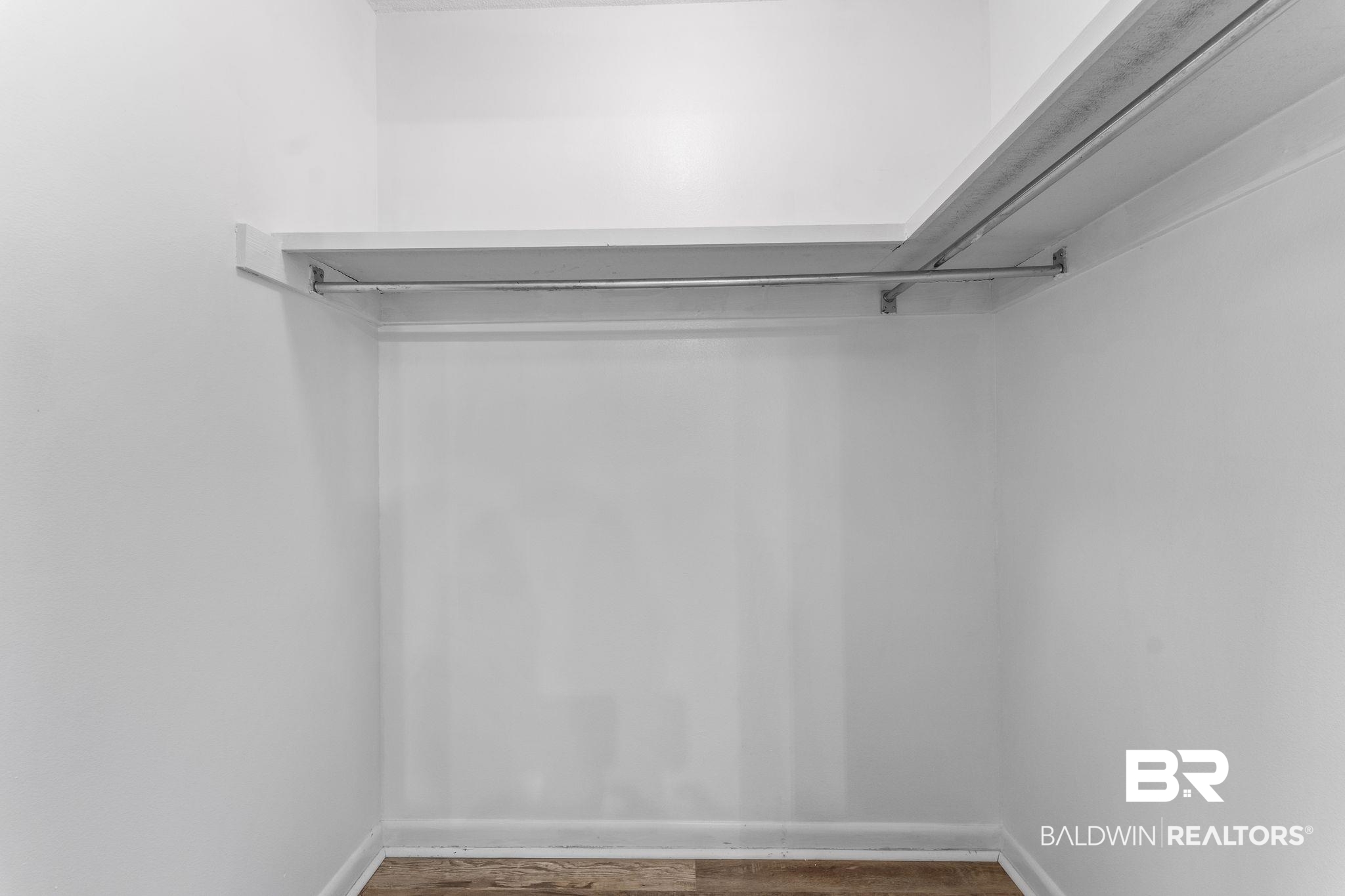 128 West Satsuma Avenue, Unit 128 Foley, AL 36535 - Photo 28 of 41 Walk in closet with wood finished floors
