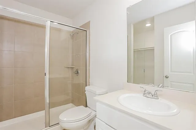 a bathroom with a sink toilet and shower