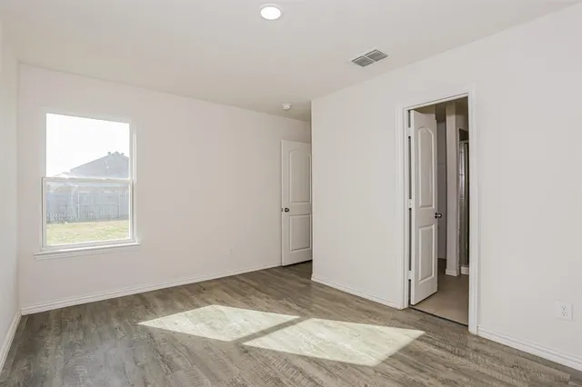 an empty room with windows and closet