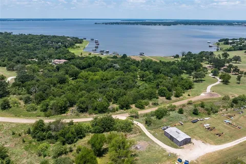 an aerial view of a houses with a yard