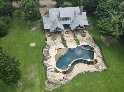 an aerial view of a house with outdoor space and lake view