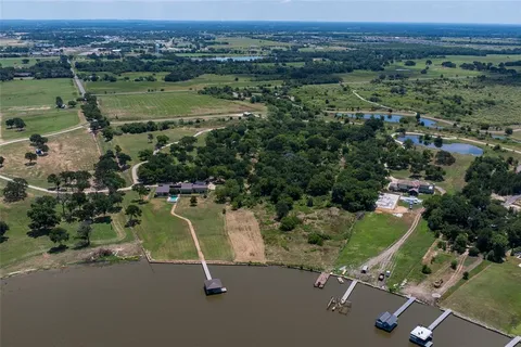 an aerial view of a houses with a lake view