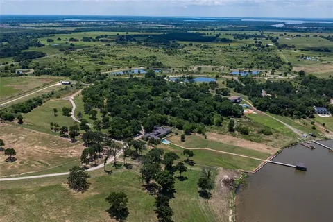 an aerial view of a houses with a yard