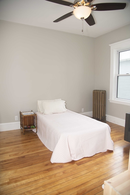 3 Chester Road, Unit 3 Belmont, MA 02478 - Photo 36 of 40 a bedroom with a bed and wooden floor