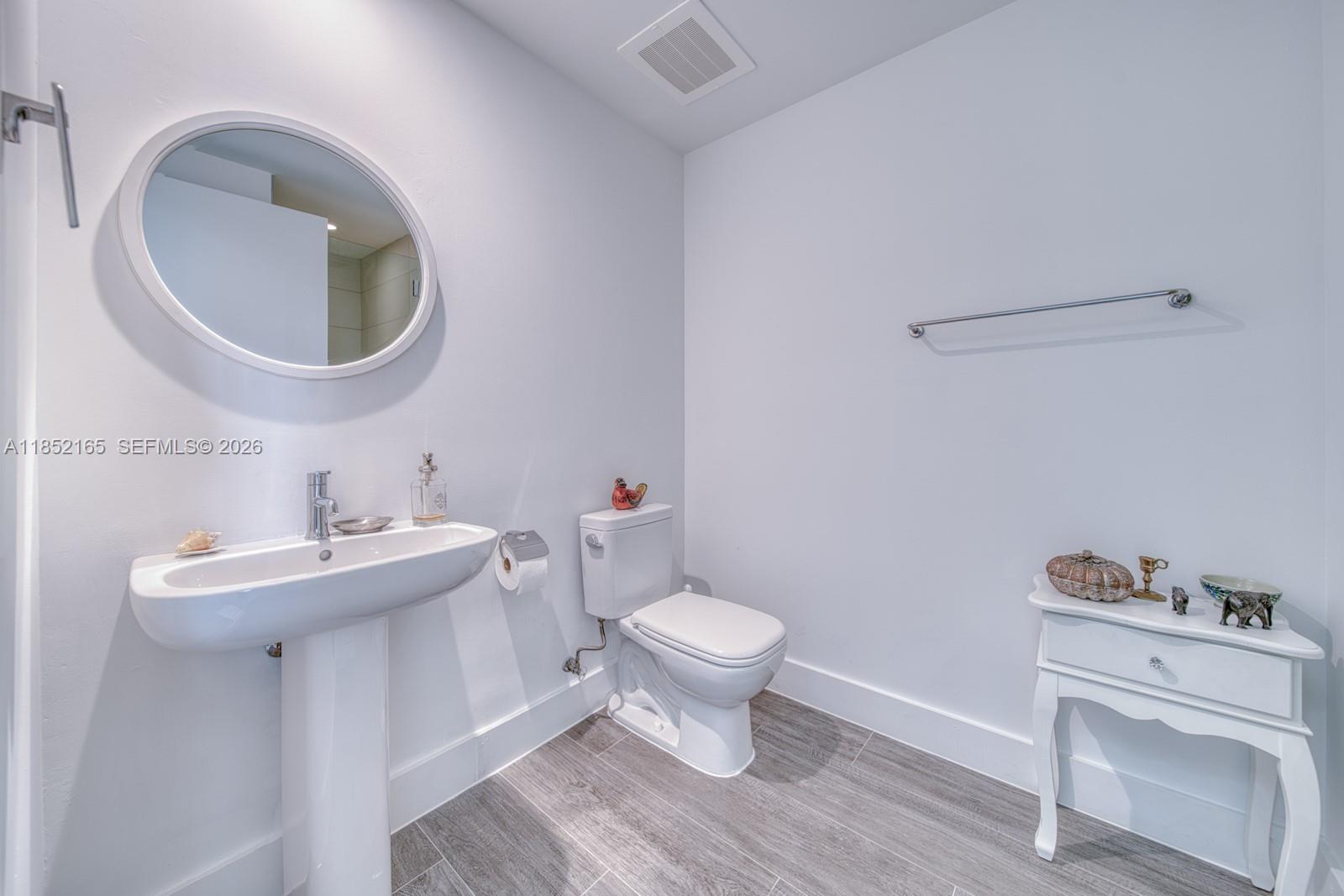 2900 Northeast 7th Avenue, Unit 405 Miami, FL 33137 - Photo 13 of 38 a bathroom with a sink toilet and a mirror