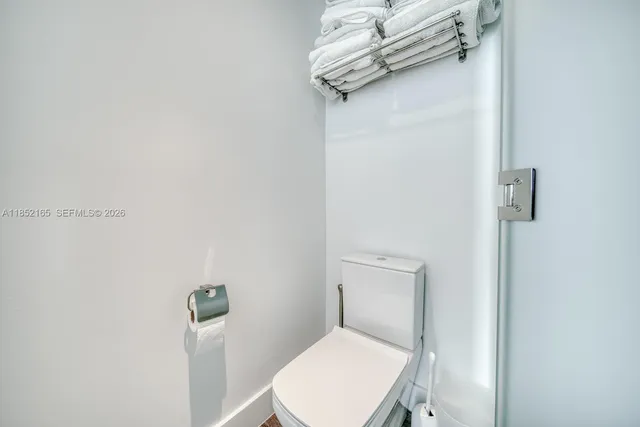 a white toilet sitting next to a bathroom sink