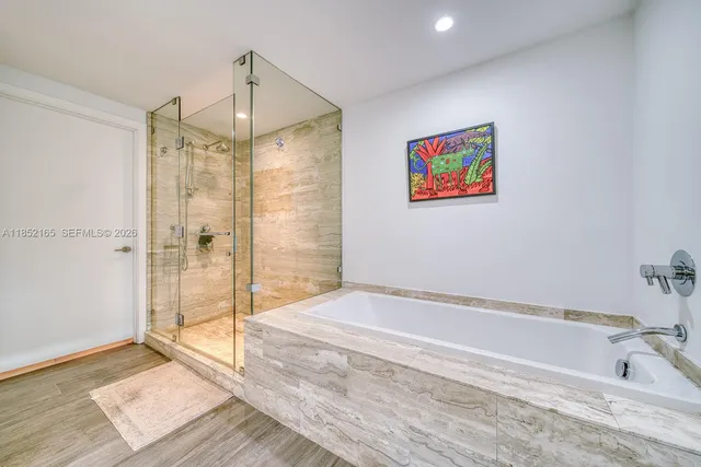 a bathroom with a tub and shower