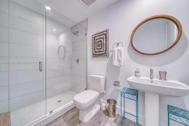 a bathroom with a toilet sink and a mirror