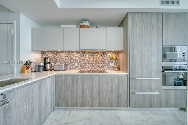 a kitchen with a sink and cabinets