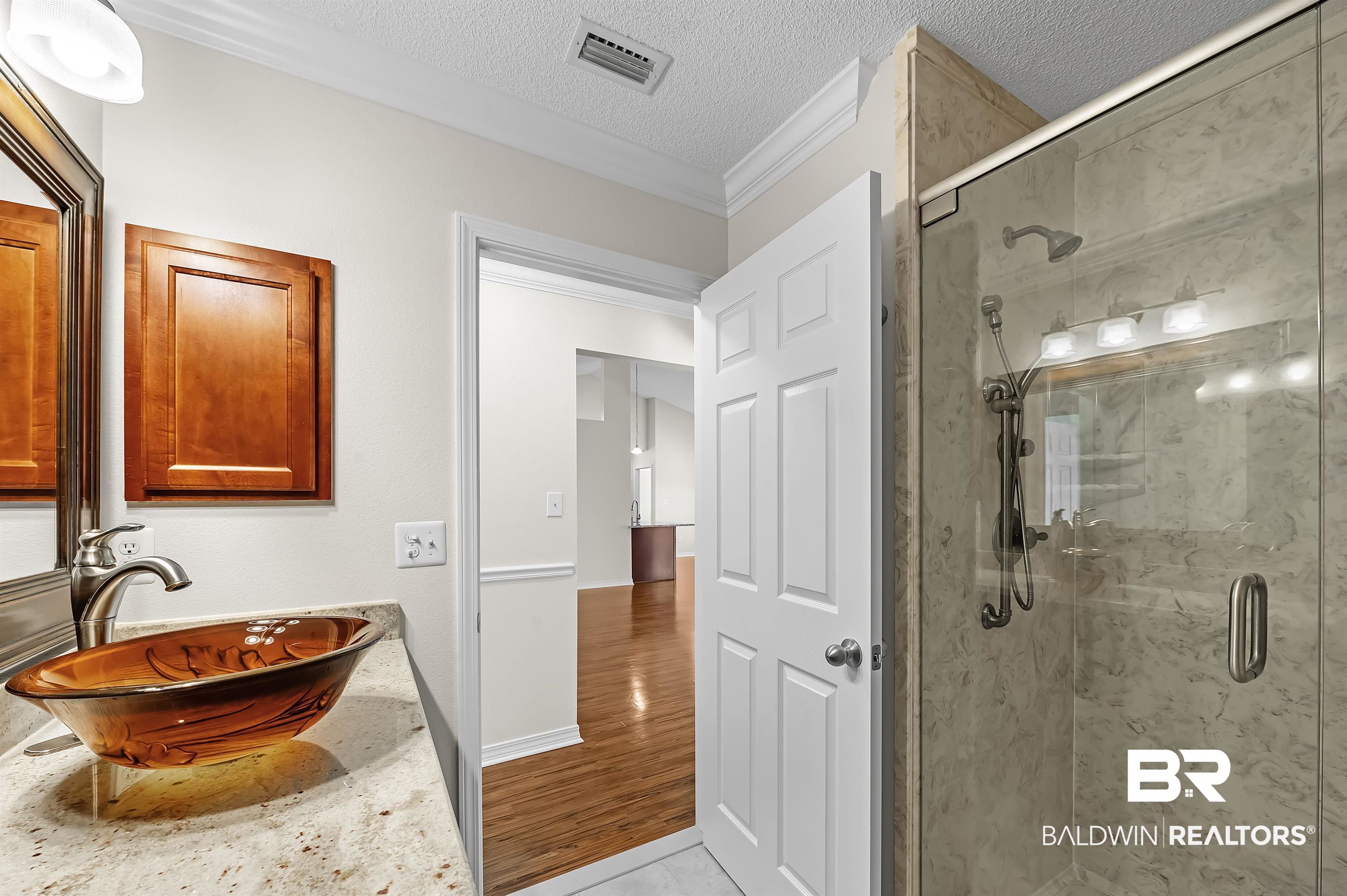 421 Collinwood Loop Foley, AL 36535 - Photo 50 of 62 Bathroom with a shower with door, crown molding, a textured ceiling, and wood-type flooring