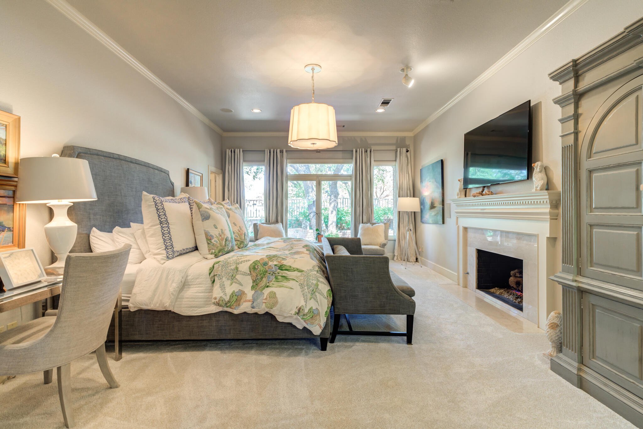 4612 91st Street Lubbock, TX 79424 - Photo 24 of 83 a spacious bedroom with a bed a flat screen tv and a fireplace