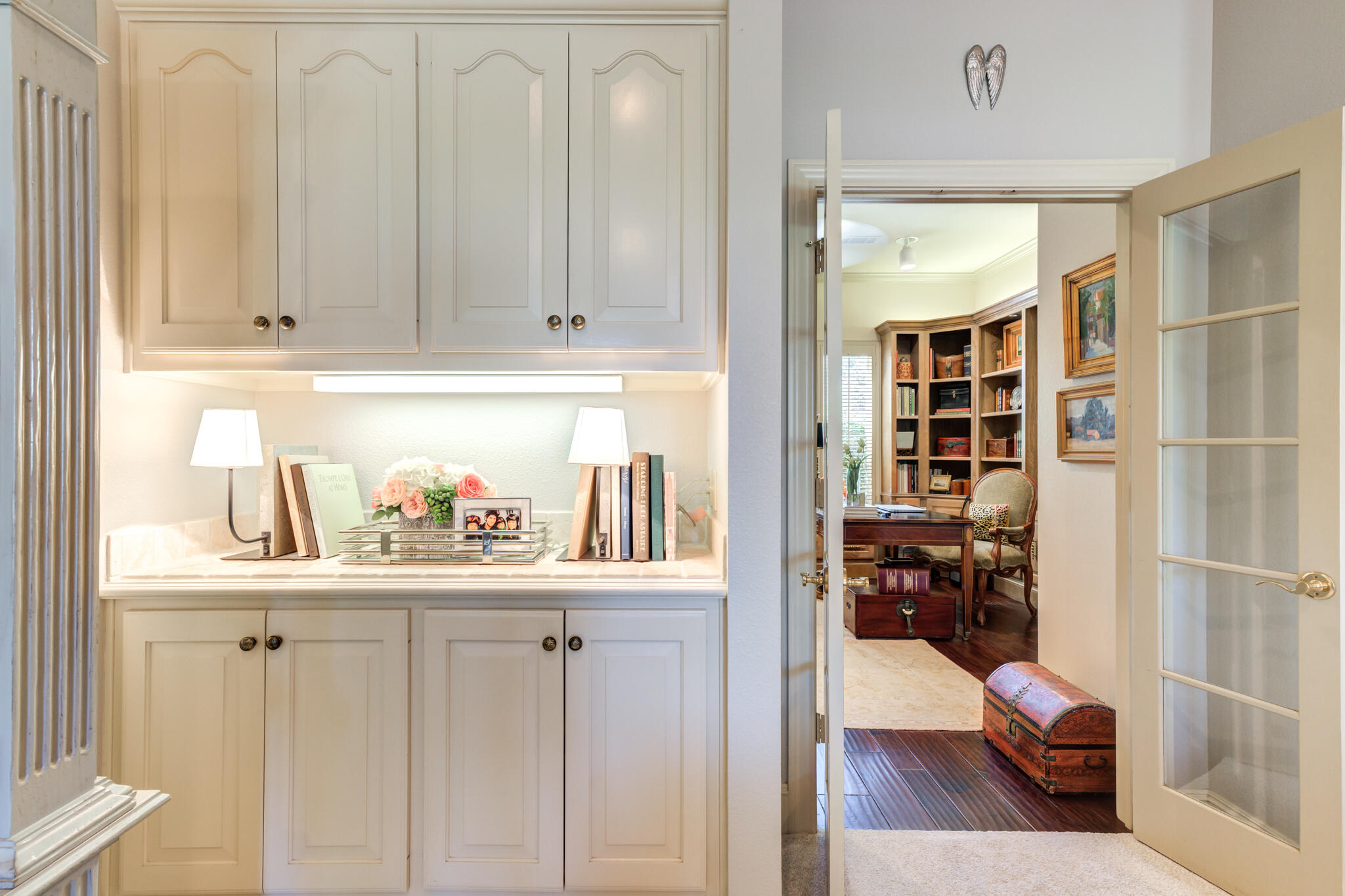 4612 91st Street Lubbock, TX 79424 - Photo 27 of 83 a kitchen with white cabinets and wooden floor