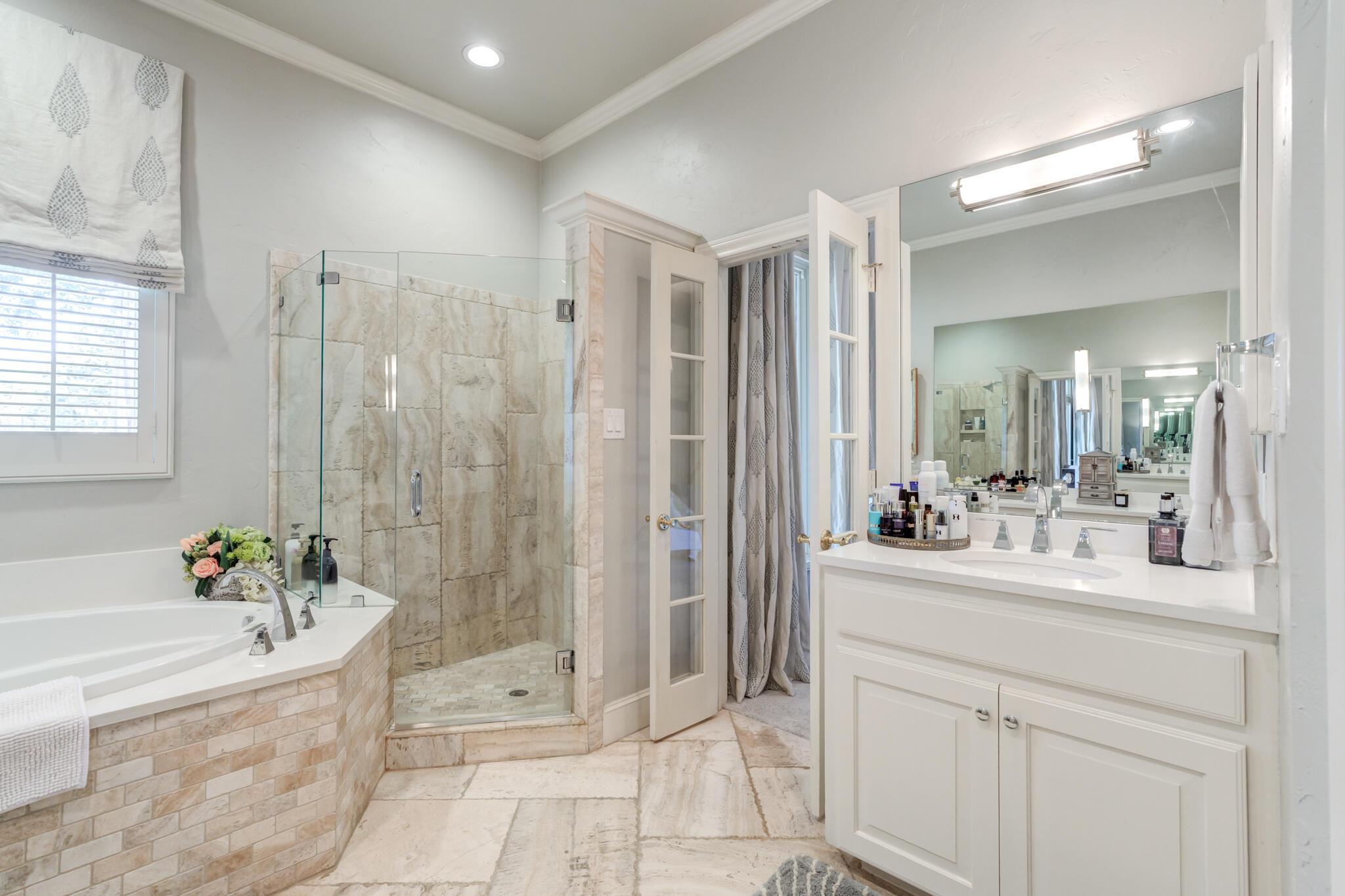 4612 91st Street Lubbock, TX 79424 - Photo 33 of 83 a bathroom with a tub sink shower and mirror
