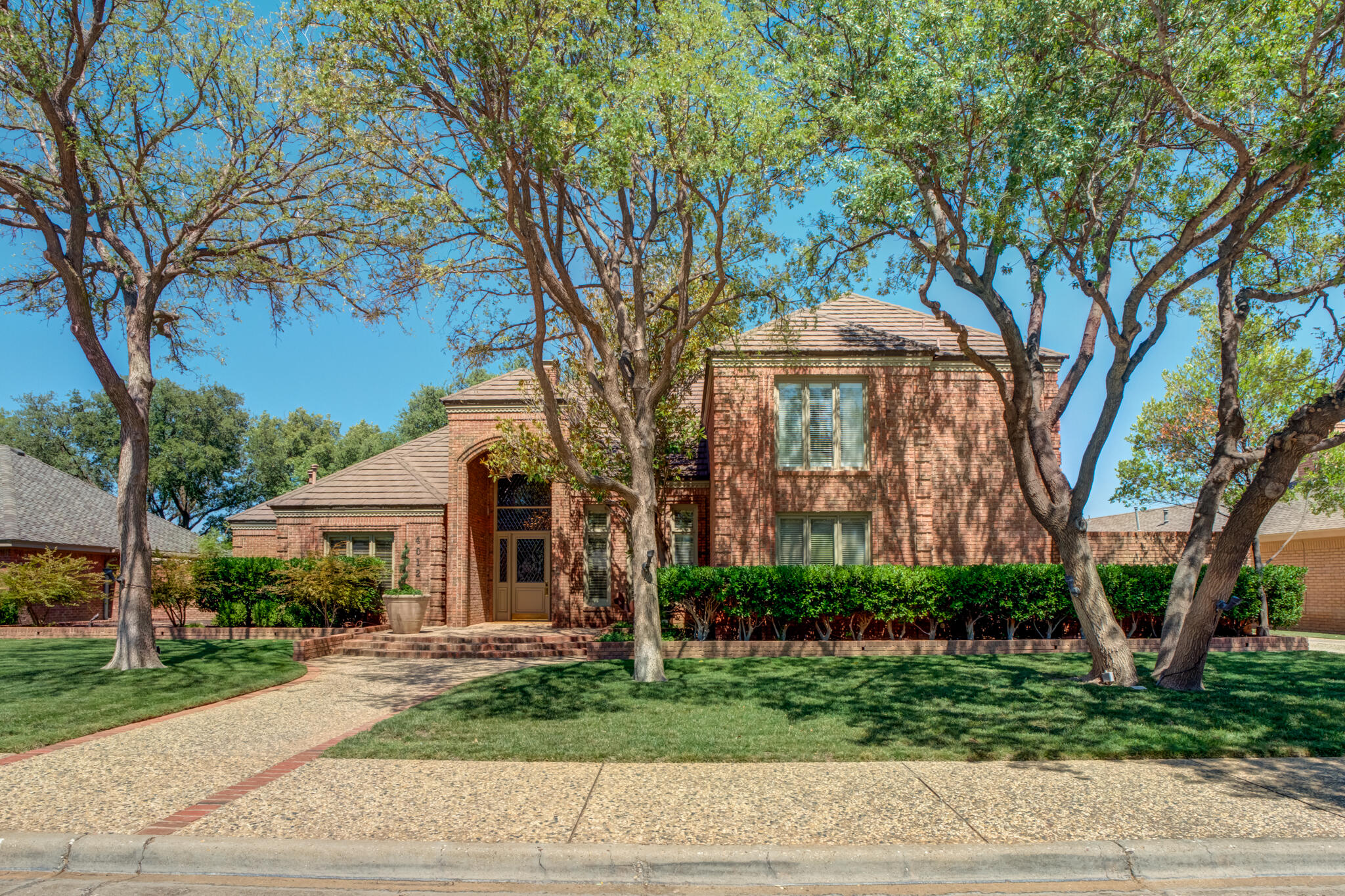4612 91st Street Lubbock, TX 79424 - Photo 4 of 83 a front view of a house with a garden