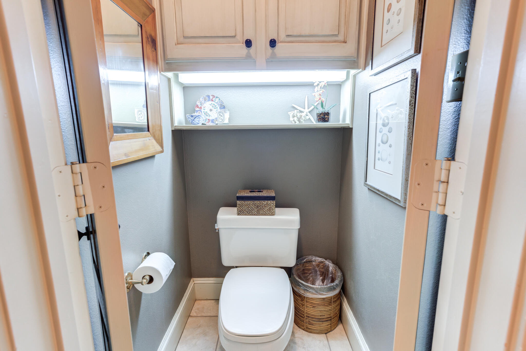 4612 91st Street Lubbock, TX 79424 - Photo 50 of 83 a white toilet sitting next to a bathroom sink and a mirror