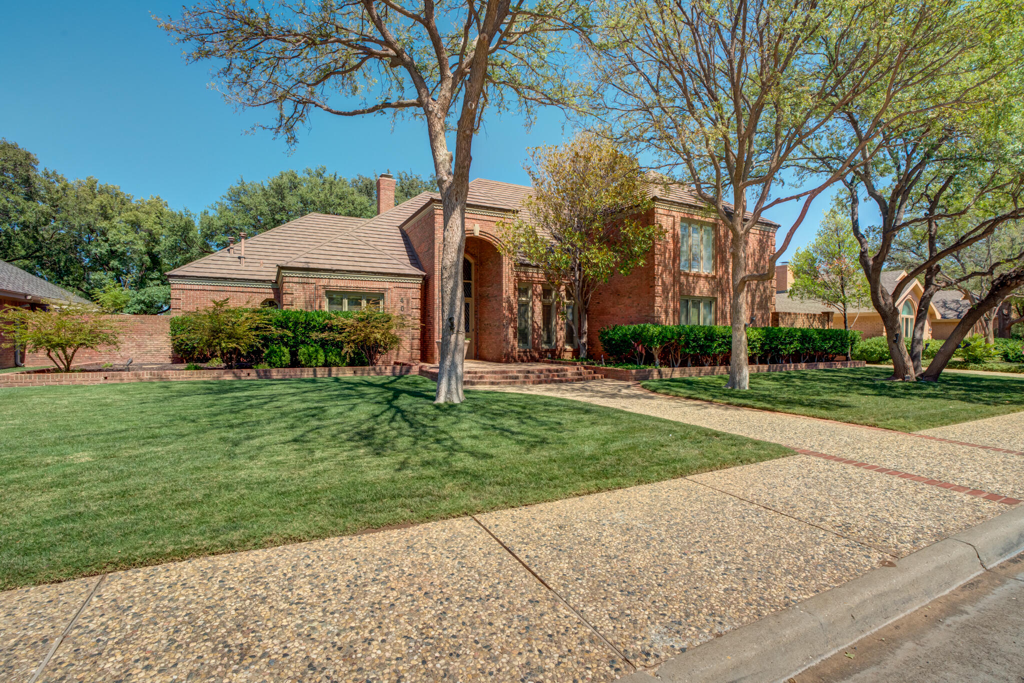 4612 91st Street Lubbock, TX 79424 - Photo 6 of 83 front view of house with a yard and potted plants