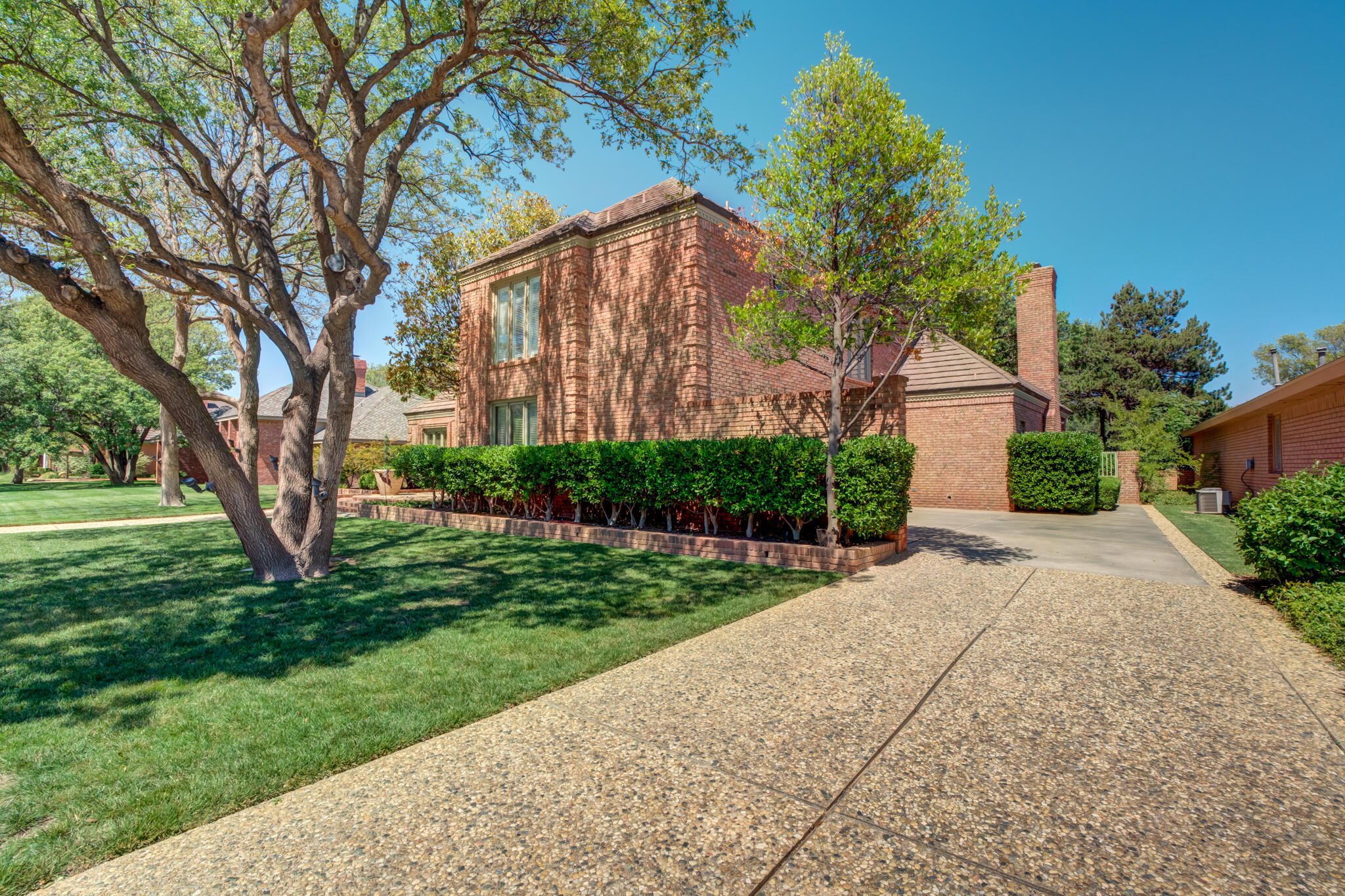 4612 91st Street Lubbock, TX 79424 - Photo 7 of 83 a front view of a house with a yard and a garden