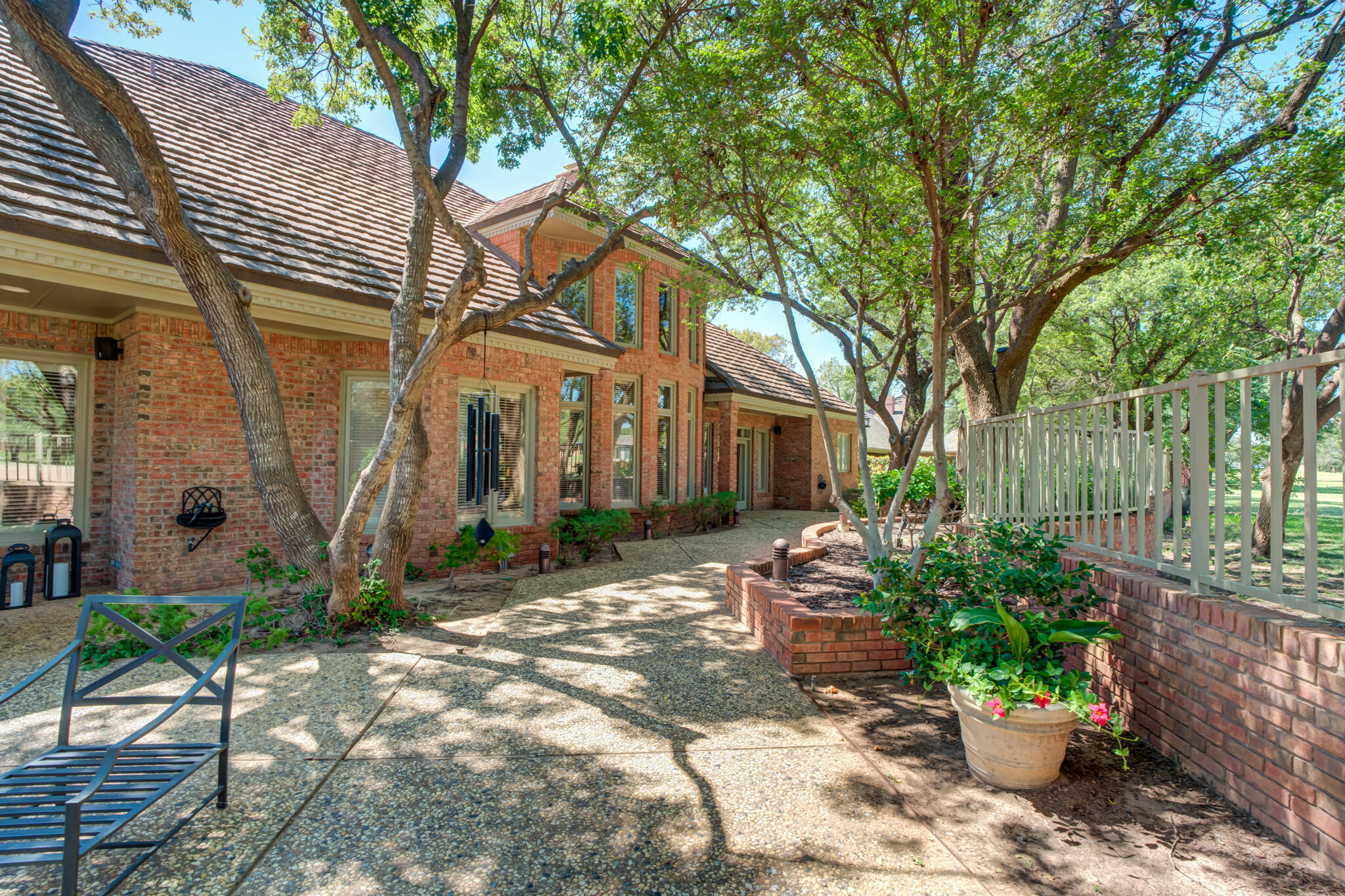 4612 91st Street Lubbock, TX 79424 - Photo 78 of 83 a backyard of a house with a garden and outdoor seating
