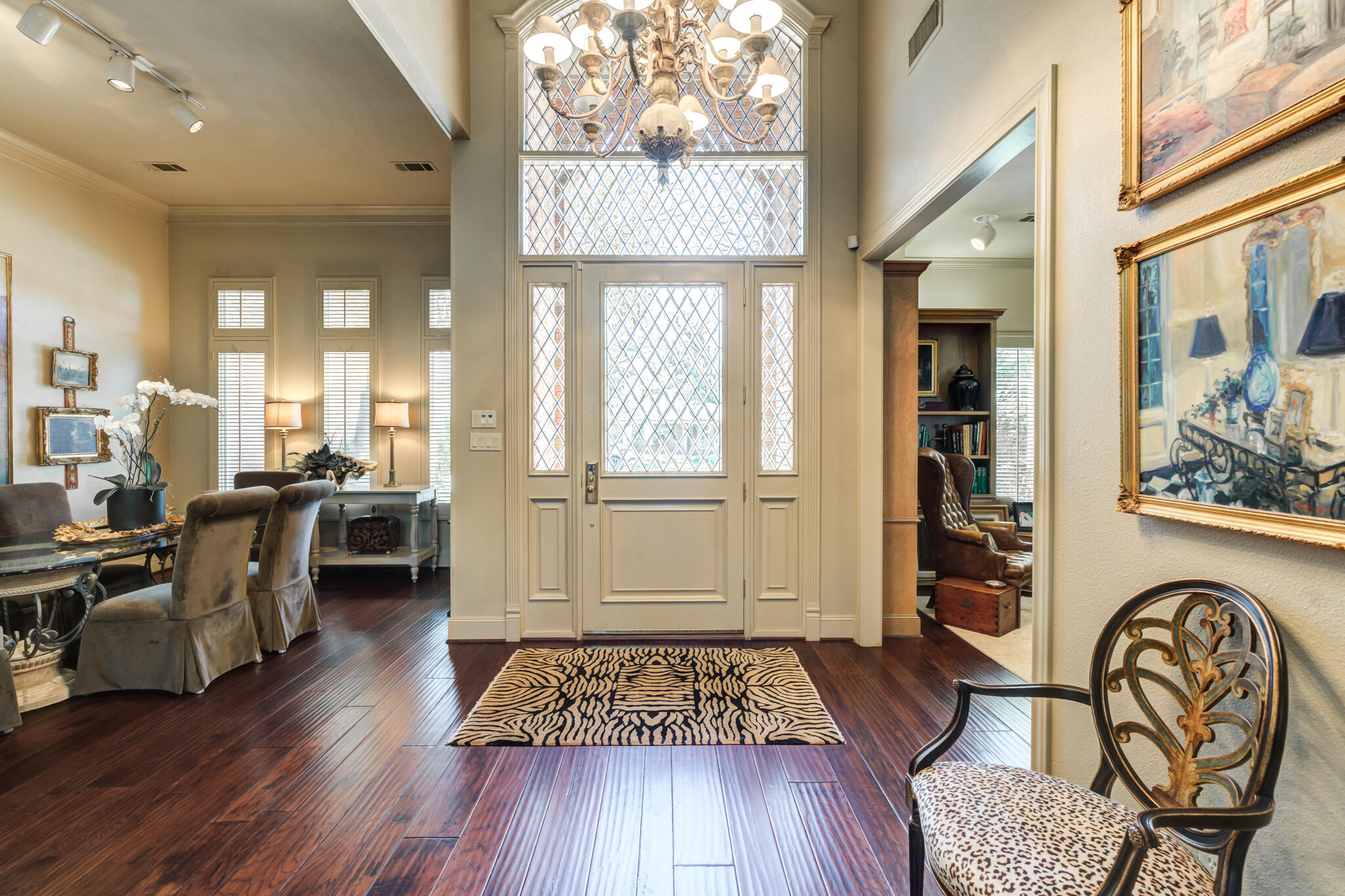 4612 91st Street Lubbock, TX 79424 - Photo 10 of 83 a living room with furniture a dining table wooden floor and a large window