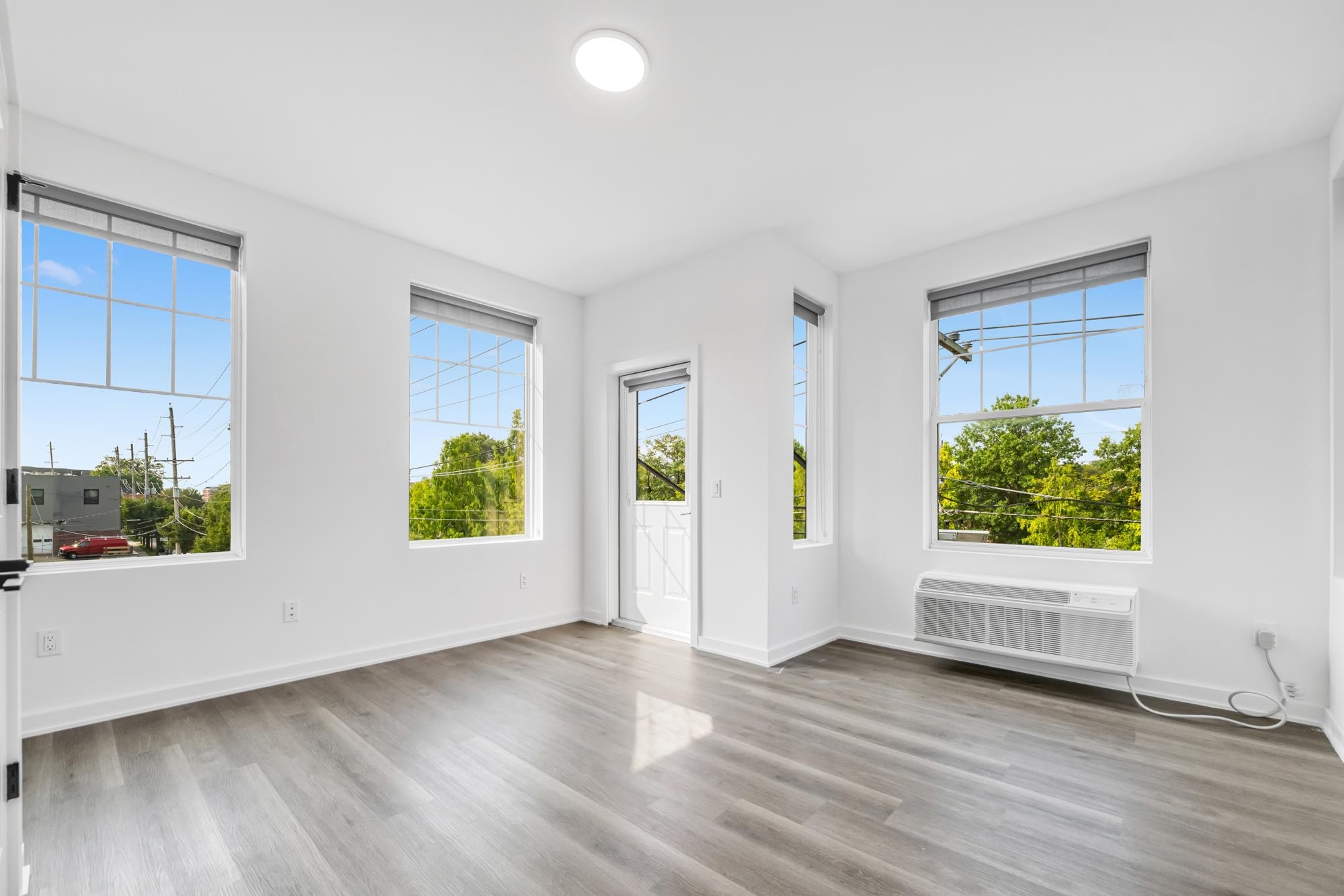 315 Railroad Avenue, Unit 204 East Rutherford, NJ 07073 - Photo 11 of 29 a view of an empty room with wooden floor and a window