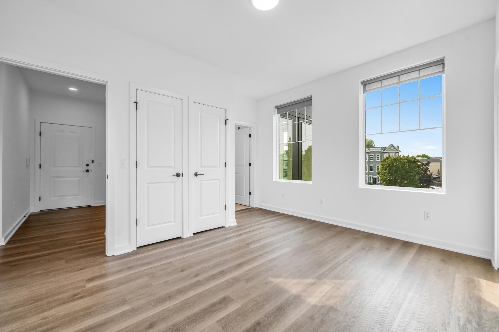 315 Railroad Avenue, Unit 204 East Rutherford, NJ 07073 - Photo 12 of 29 a view of an empty room with wooden floor and a window