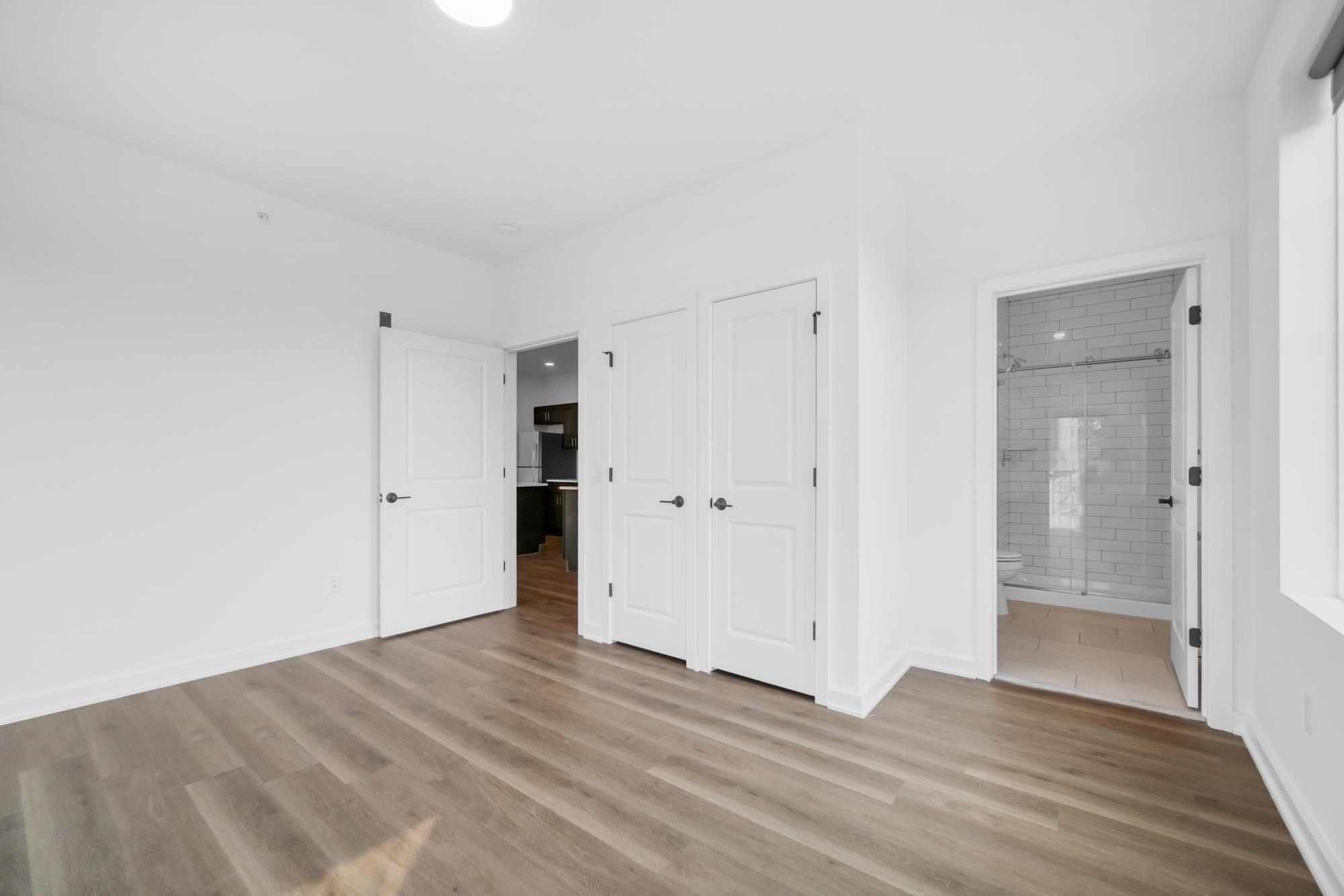 315 Railroad Avenue, Unit 204 East Rutherford, NJ 07073 - Photo 13 of 29 a view of an empty room with wooden floor