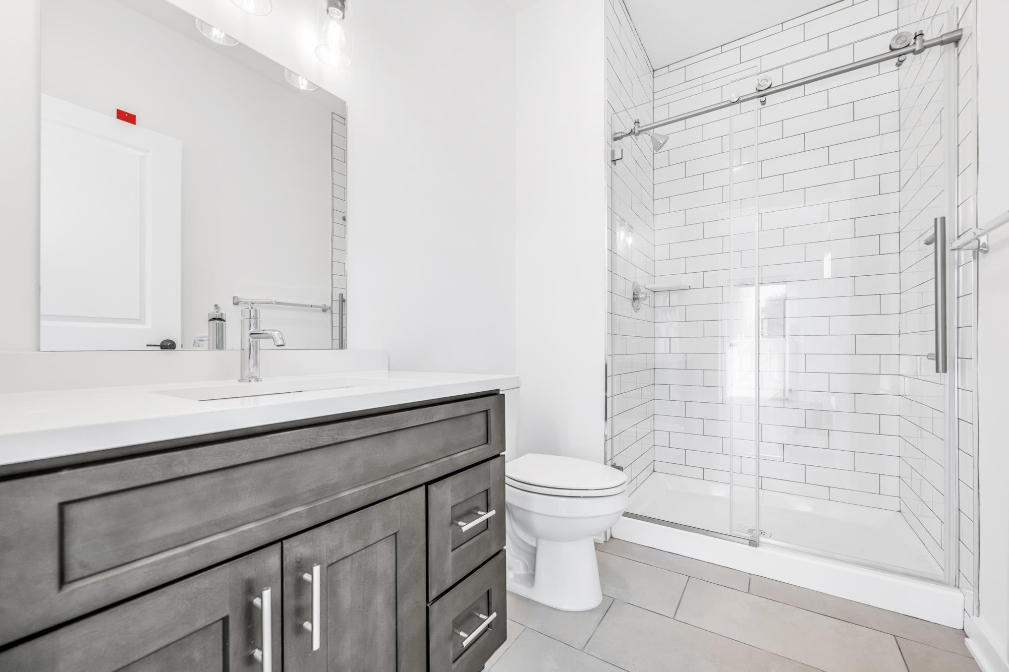 315 Railroad Avenue, Unit 204 East Rutherford, NJ 07073 - Photo 14 of 29 a bathroom with a sink a toilet and shower