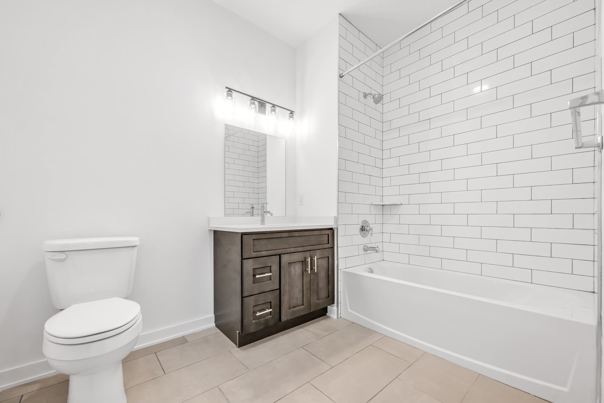 315 Railroad Avenue, Unit 204 East Rutherford, NJ 07073 - Photo 18 of 29 a bathroom with a sink a toilet and bathtub