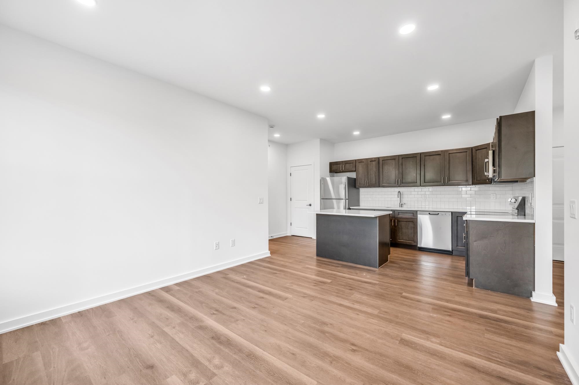 315 Railroad Avenue, Unit 204 East Rutherford, NJ 07073 - Photo 2 of 29 a large kitchen with stainless steel appliances kitchen island a large counter top and a stove top oven