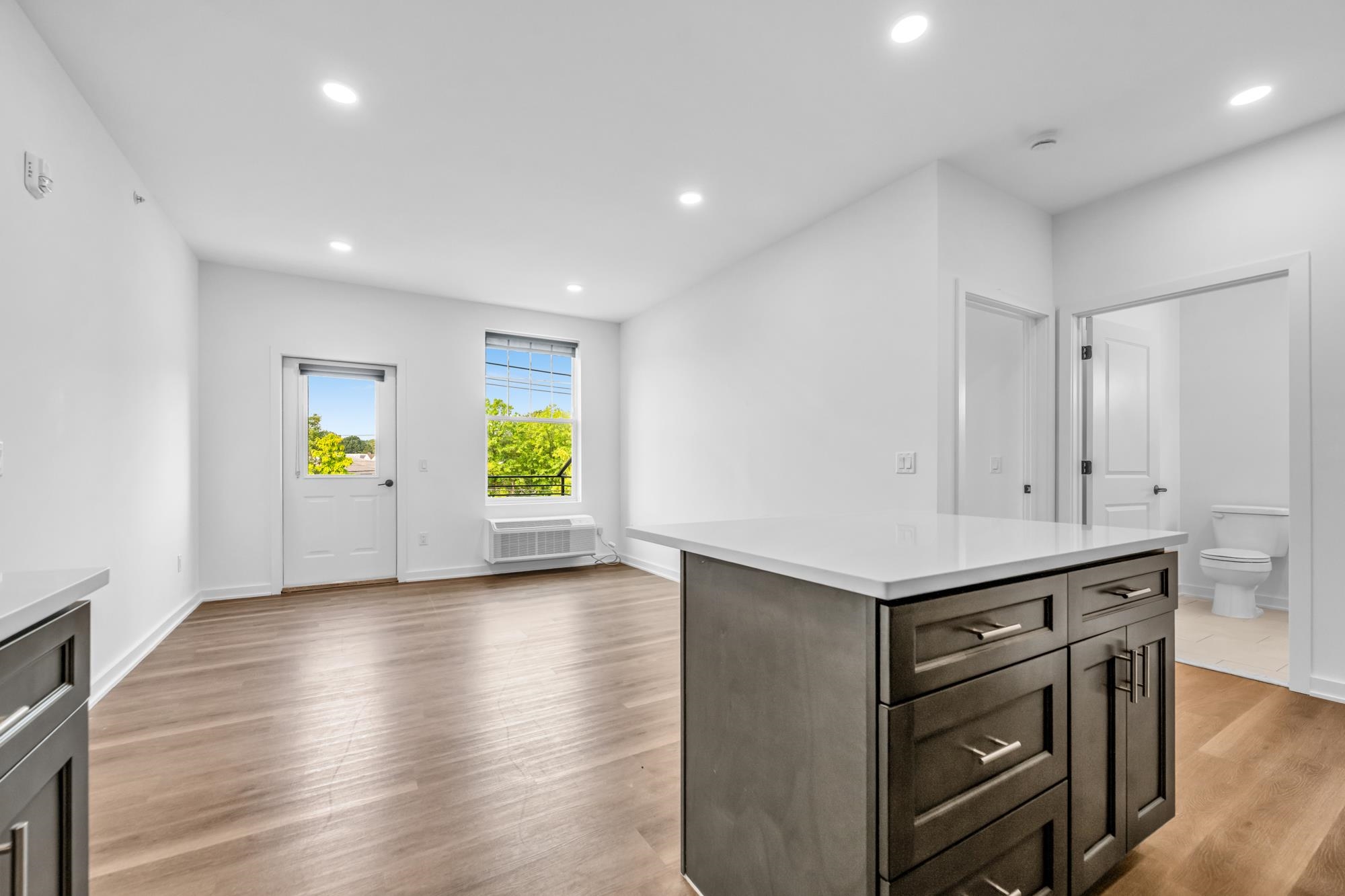 315 Railroad Avenue, Unit 204 East Rutherford, NJ 07073 - Photo 3 of 29 an empty room with windows and wooden floor