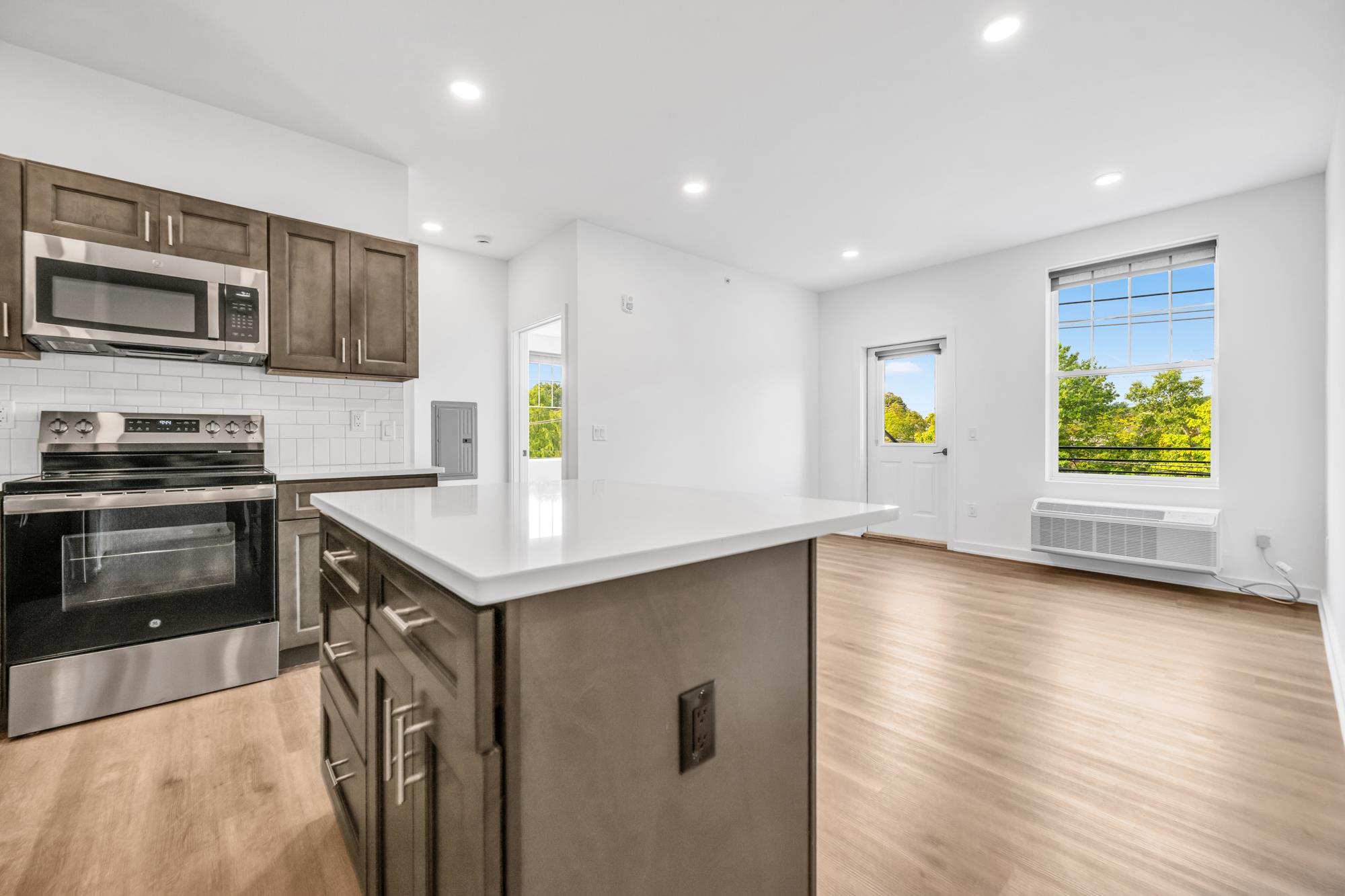315 Railroad Avenue, Unit 204 East Rutherford, NJ 07073 - Photo 5 of 29 a kitchen with stainless steel appliances granite countertop a stove top oven a sink and a refrigerator
