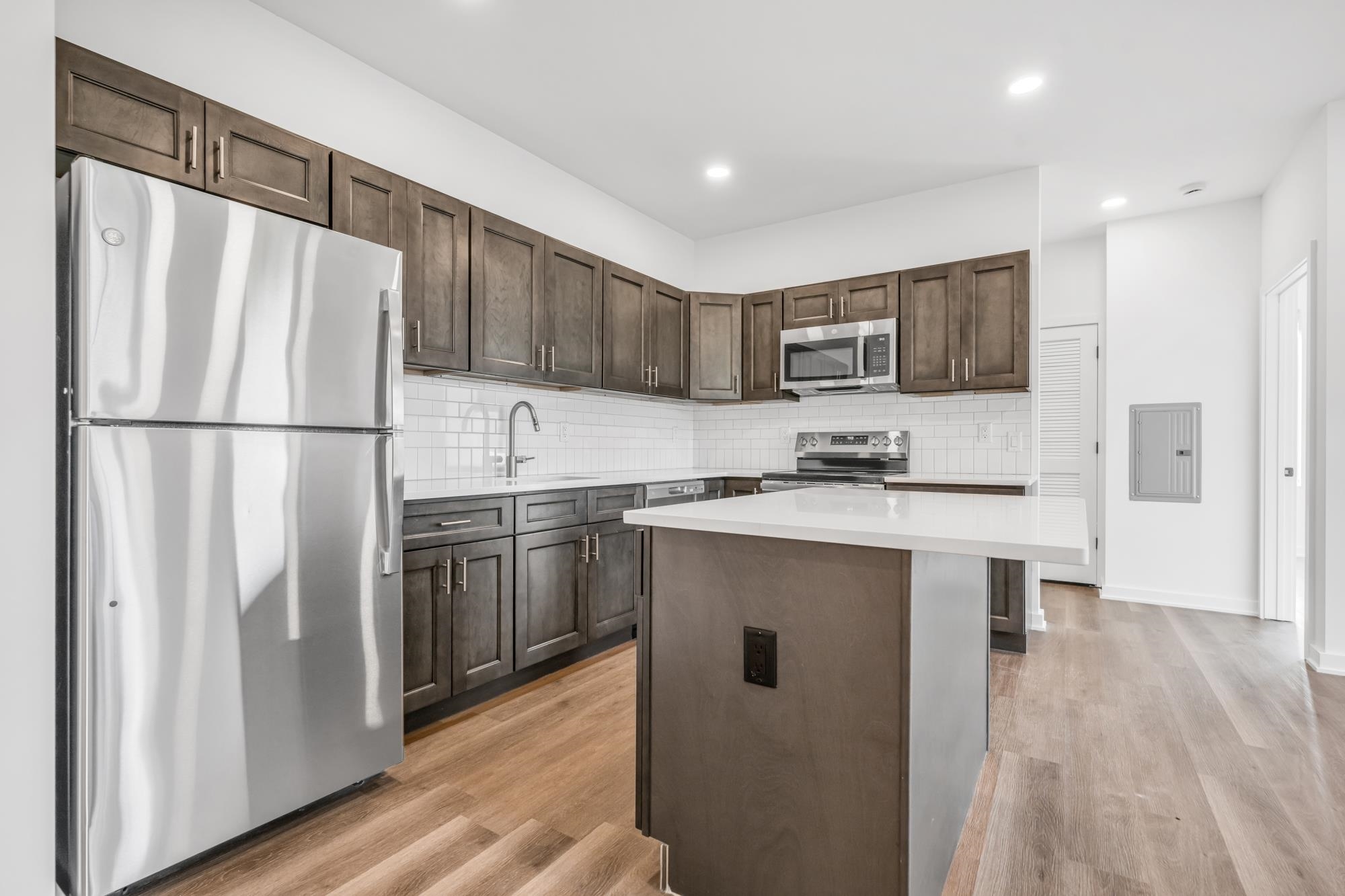 315 Railroad Avenue, Unit 204 East Rutherford, NJ 07073 - Photo 7 of 29 a kitchen with stainless steel appliances a refrigerator sink and microwave