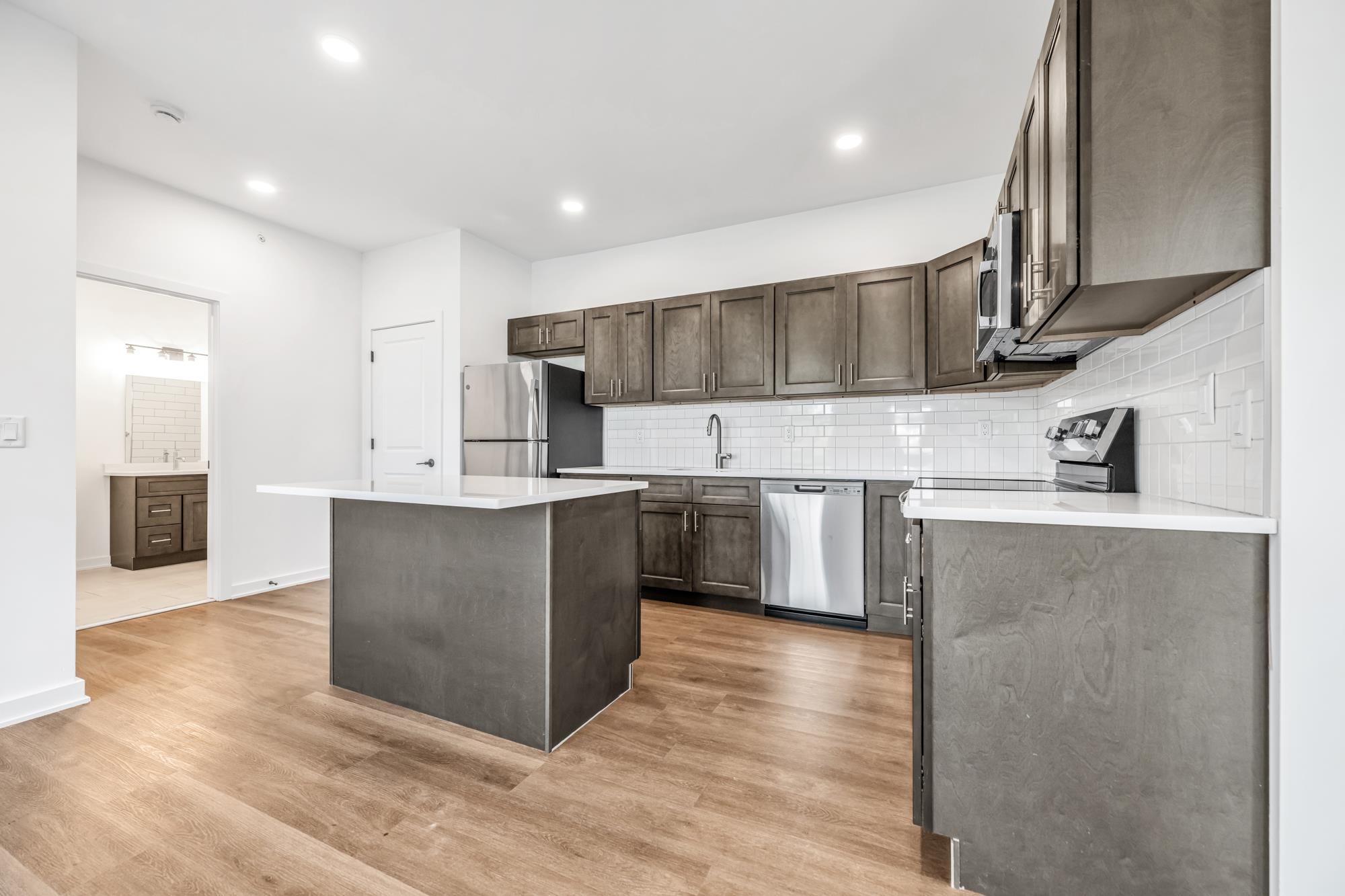 315 Railroad Avenue, Unit 204 East Rutherford, NJ 07073 - Photo 8 of 29 a kitchen with stainless steel appliances kitchen island granite countertop a refrigerator and a sink