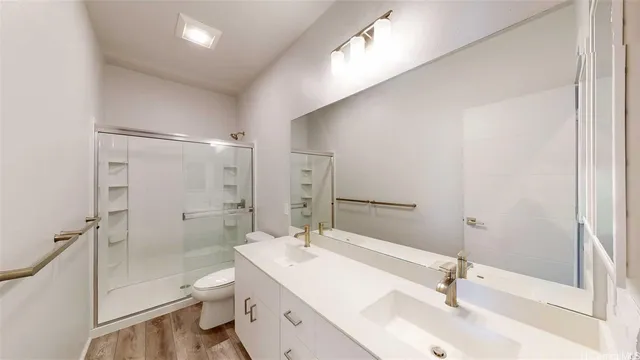 an empty room with closet and a chandelier fan