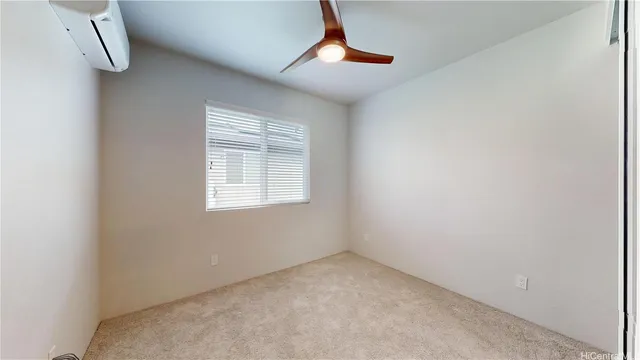 a view of empty room with air conditioner and window